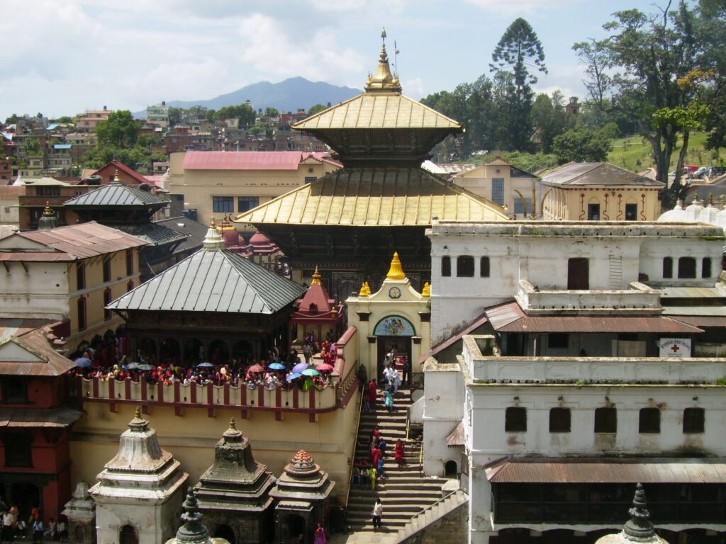 The main golden temple of Pashupatinath flanked by some of the other temples with Kathmandu in the background.